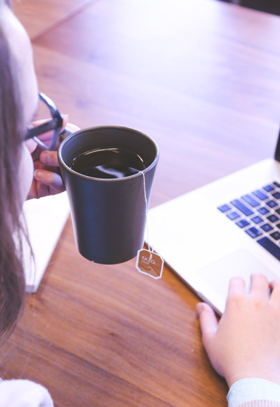 Digital solutions team collaborating with technology and tea